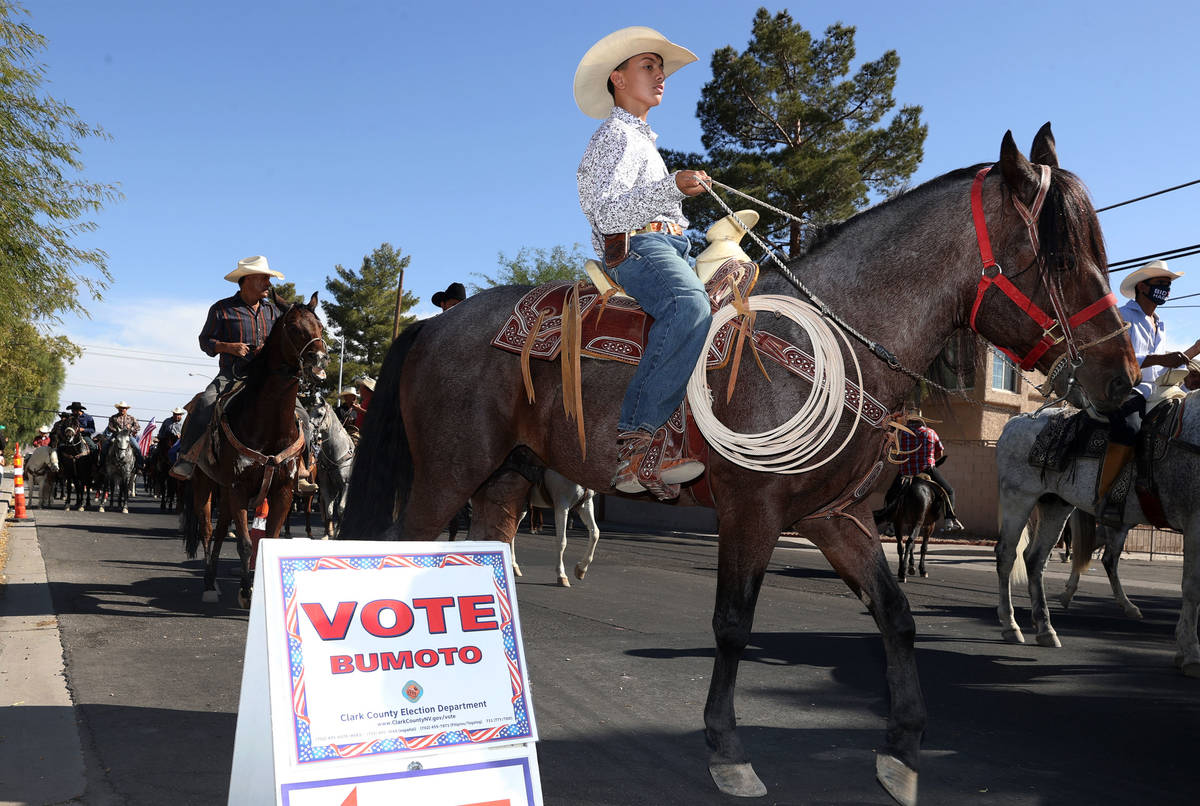 Horseback riders participate during a campaign parade for Assemblyman Edgar Flores and the Bide ...