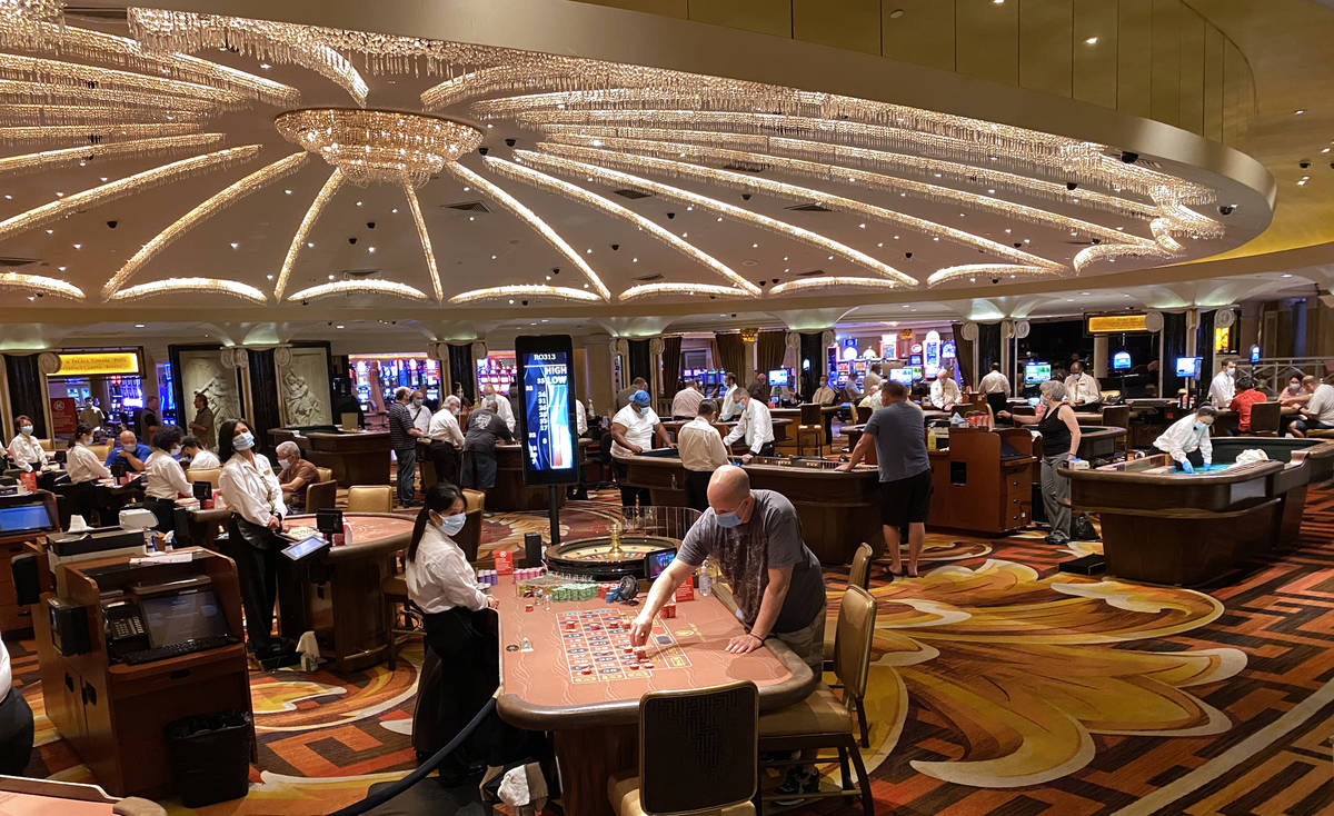 Gamblers don protective face masks at Caesars Palace on the Las Vegas Strip in this June 24, 20 ...