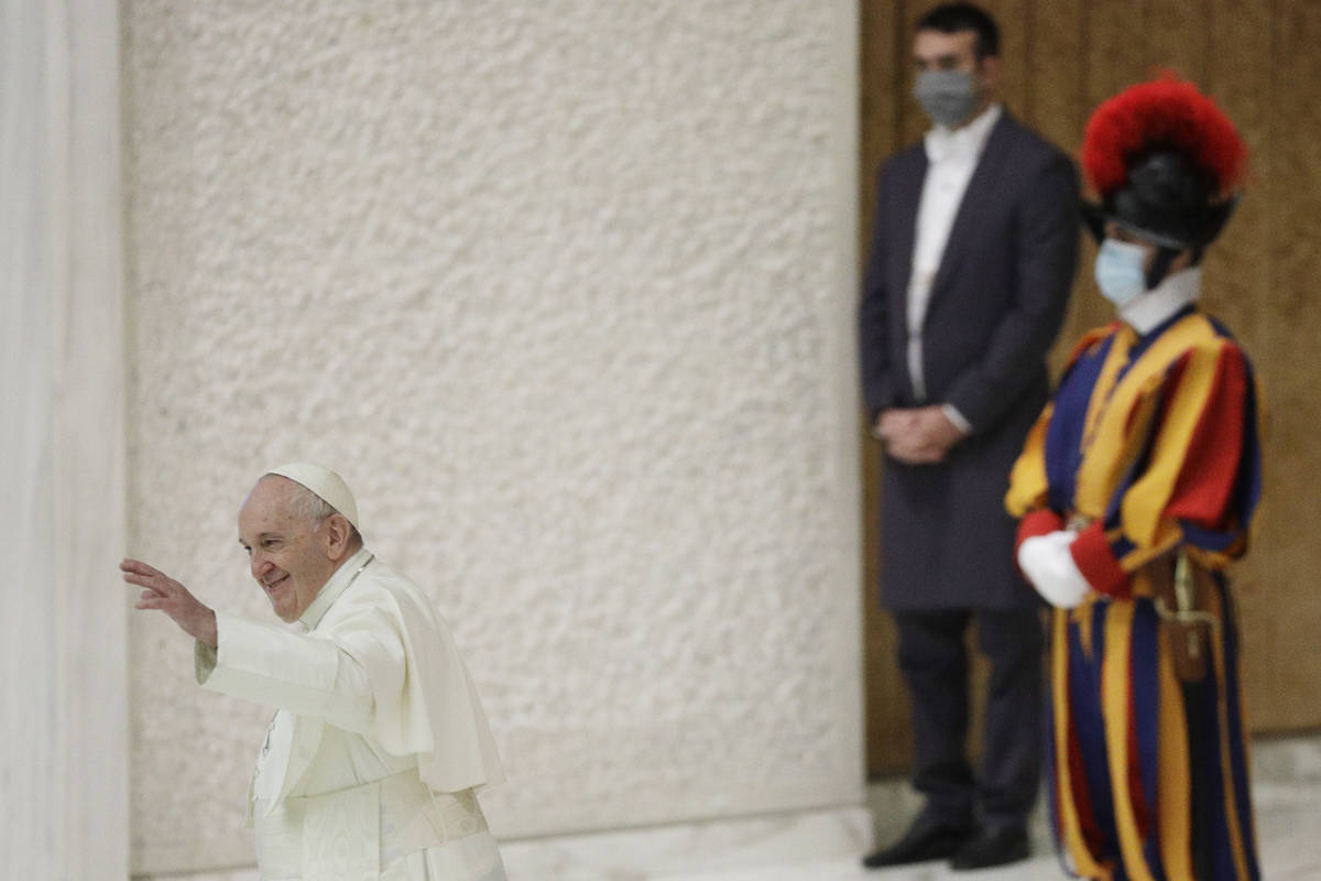 Pope Francis waves at the end of his weekly general audience in the Paul VI hall at the Vatican ...