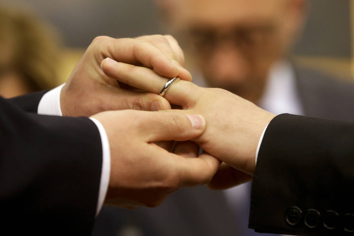 In a May 21, 2015, file photo, Mauro Cioffari, left, puts a wedding ring on his partner Davide ...