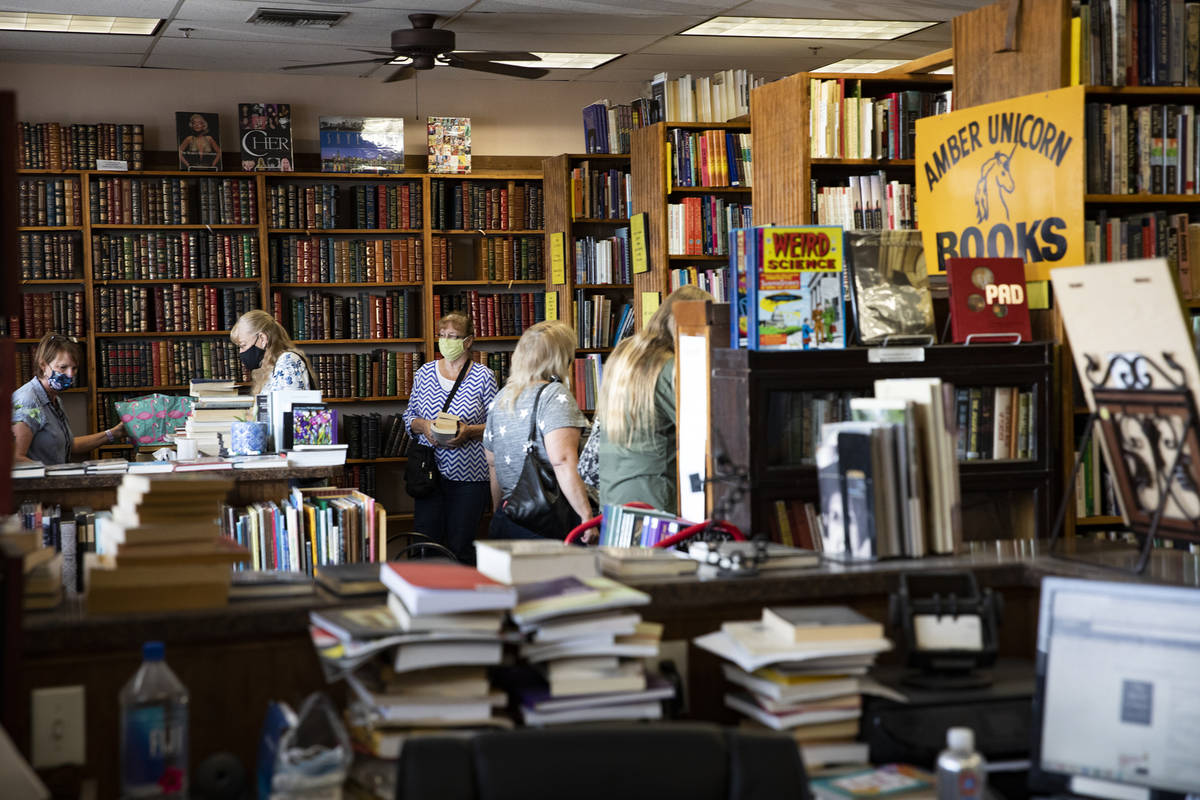 Customers shop for books at Amber Unicorn Books in Las Vegas, Wednesday, Oct. 21, 2020. The sto ...
