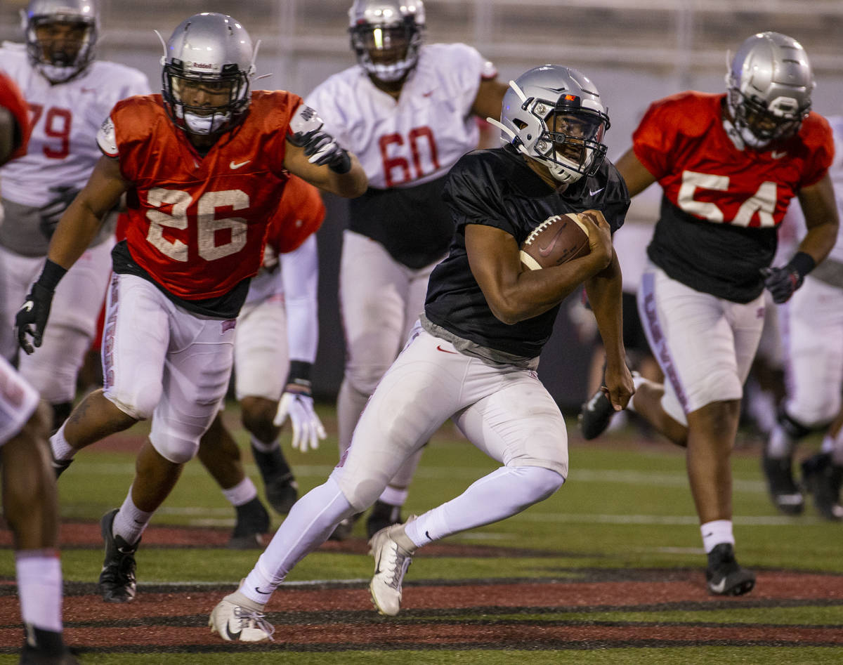 QB Marckell Grayson (15) breaks into open territory past defenders during the UNLV football tea ...