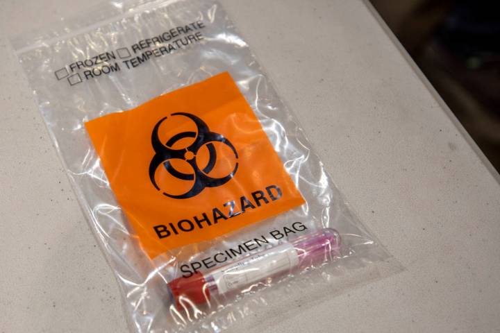 A completed COVID-19 test is seen in a biohazard bag during a preview of COVID-19 testing site ...