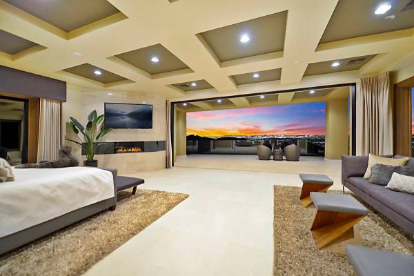 The upstairs master suite features a disappearing wall that allows for sweeping views of the La ...