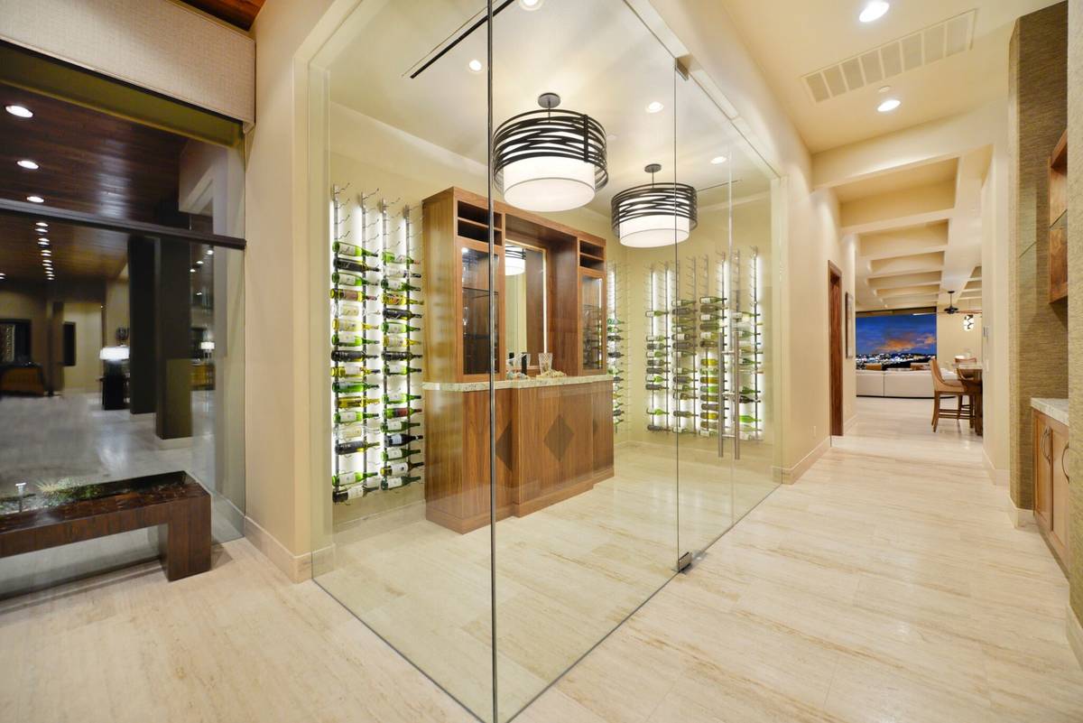 The luxury home has a lot of special spaces, including a wine cellar. The back of the home has ...