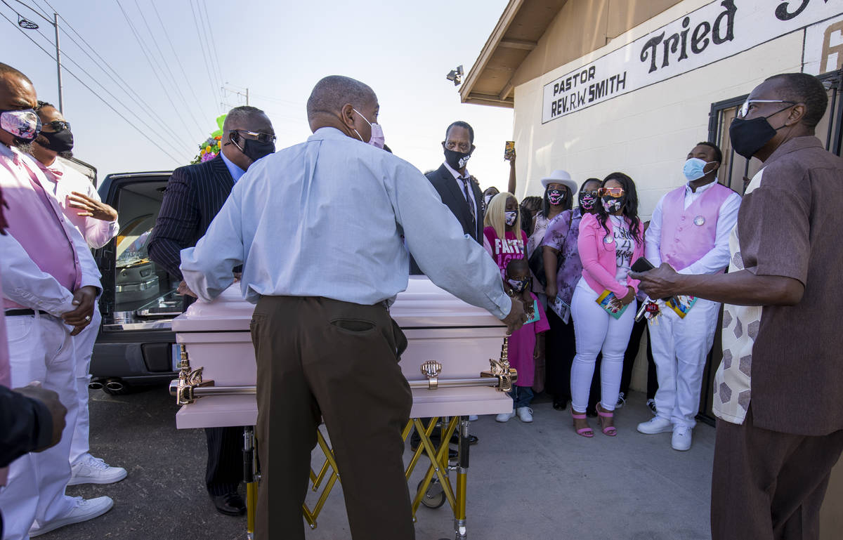 Family and friends gather outside as the casket is brought inside for the funeral service for S ...