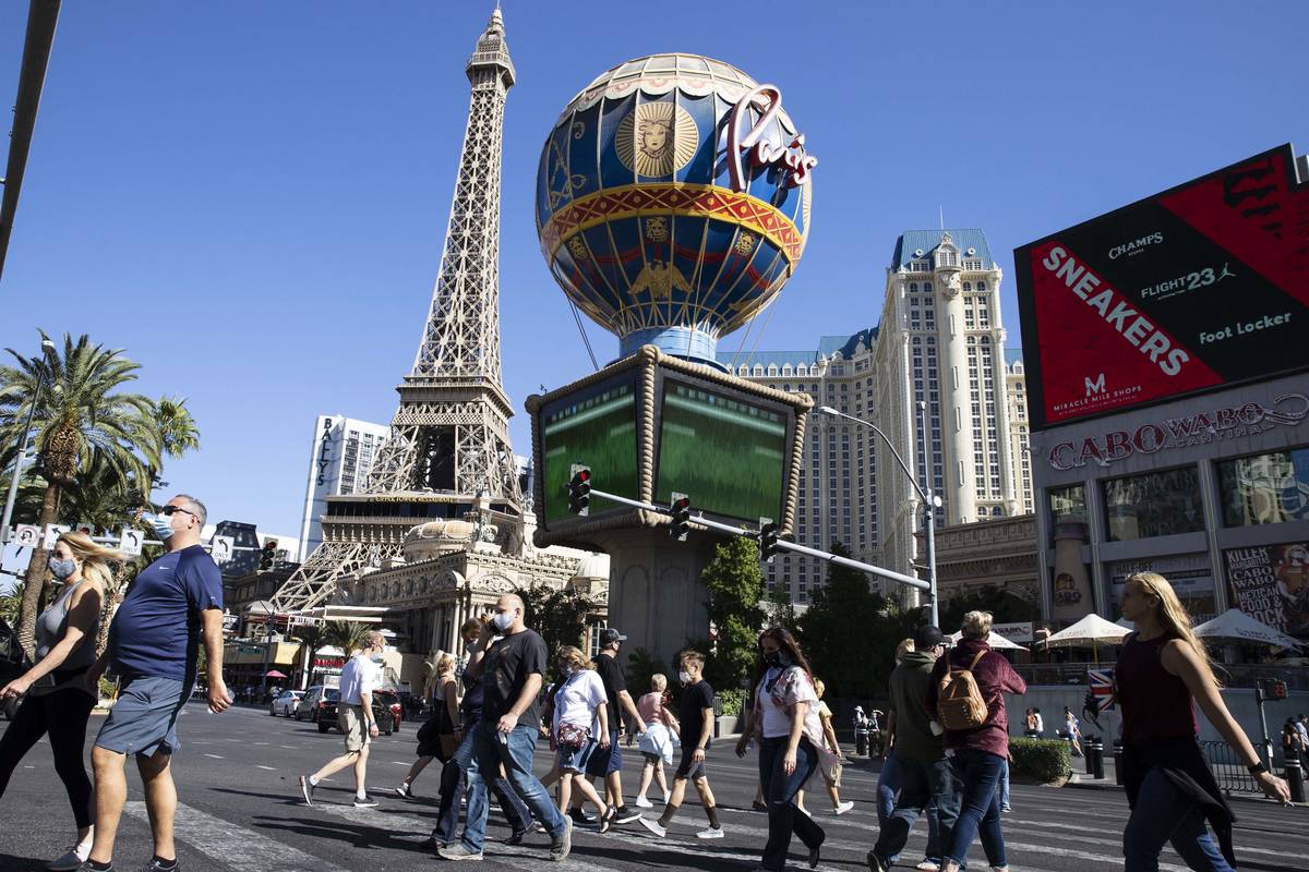 Tourist walk past Paris Las Vegas on Friday, Oct. 23, 2020, in Las Vegas. Hundreds of guests at ...