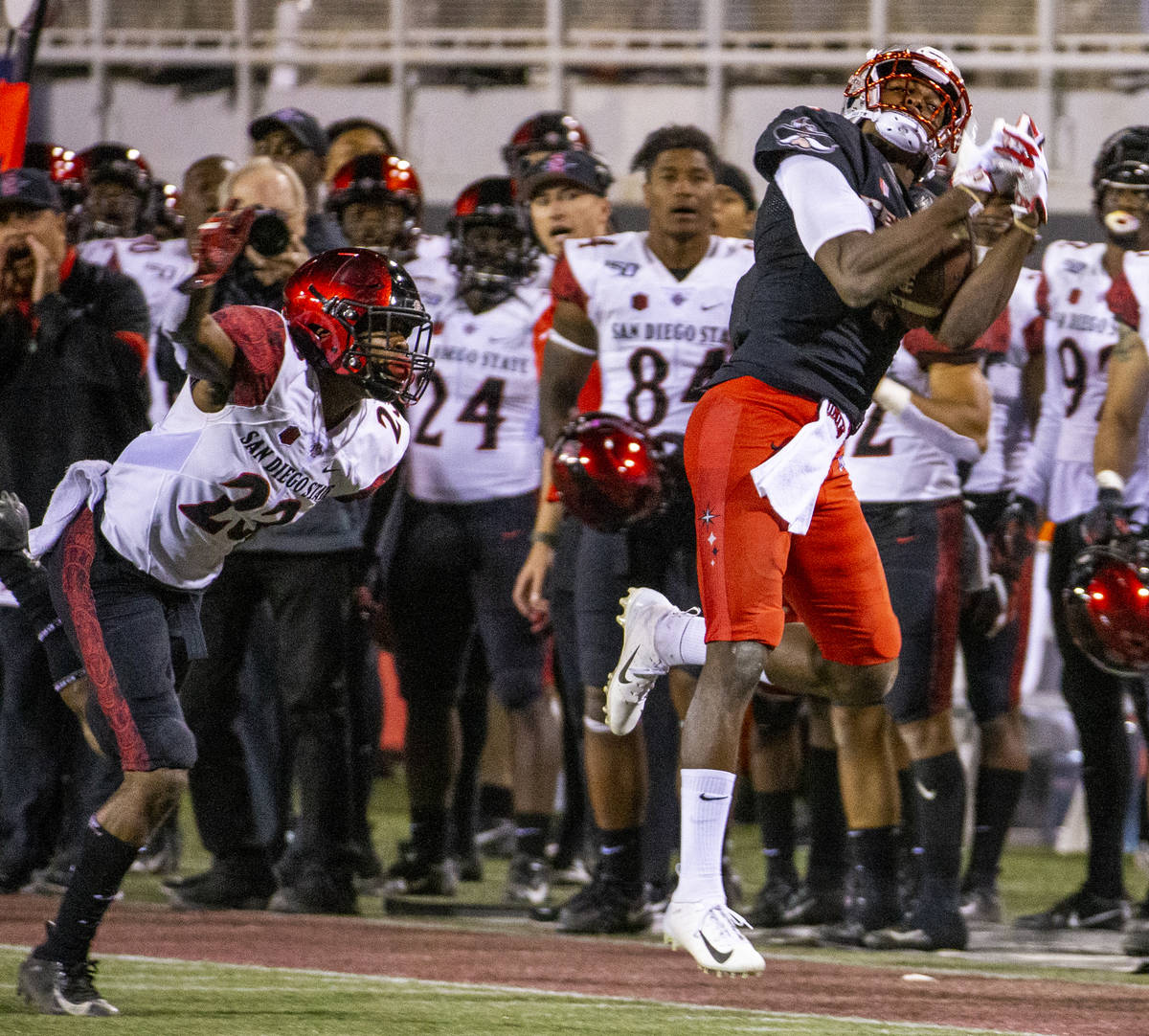 UNLV Rebels wide receiver Randal Grimes (4, right) secure a long pass reception over San Diego ...