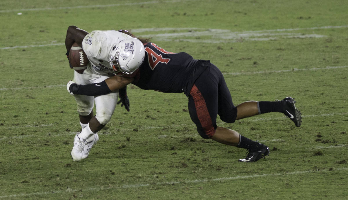 UNLV’s Charles Williams is tackled by San Diego State’s Michael Shawcroft during Saturday's ...