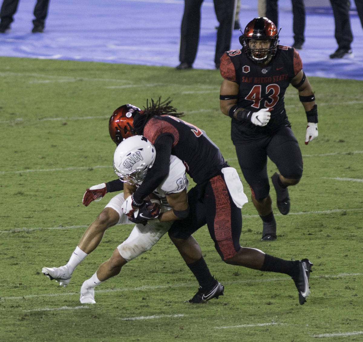 UNLV’s Jacob Gasser is tackled by San Diego State’s Dwayne Johnson Jr. during Saturday's Mo ...