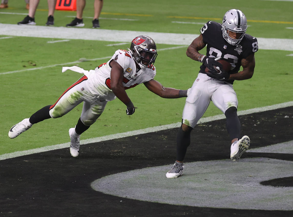 Las Vegas Raiders tight end Darren Waller (83) pulls in a touchdown pass in front of Tampa Bay ...