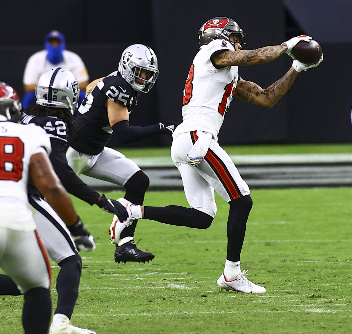 Tampa Bay Buccaneers wide receiver Mike Evans (13) catches a pass in front of Las Vegas Raiders ...