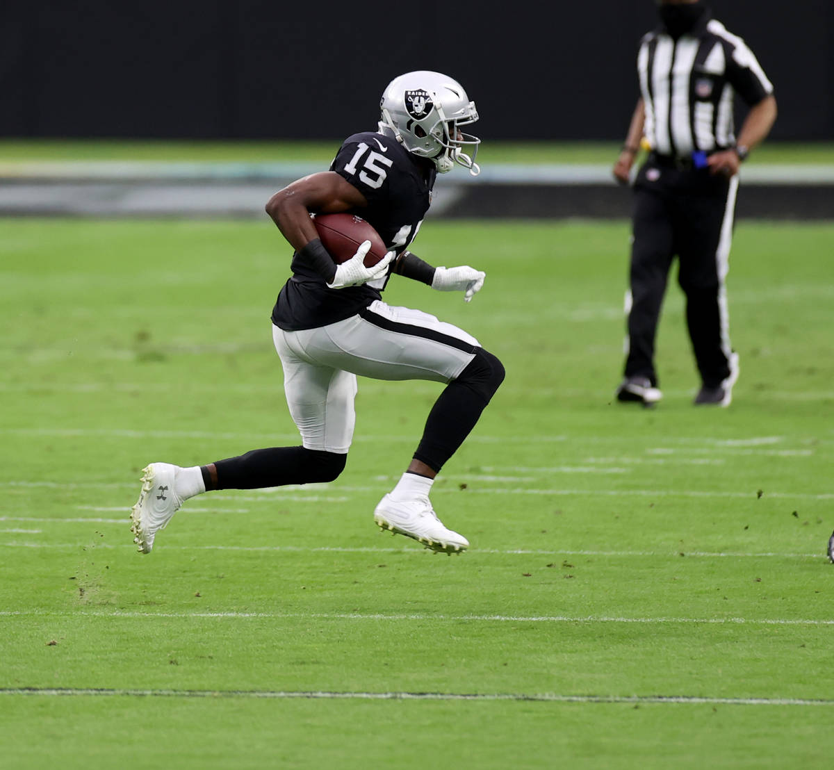 Las Vegas Raiders wide receiver Nelson Agholor (15) runs the ball after making a catch in the f ...
