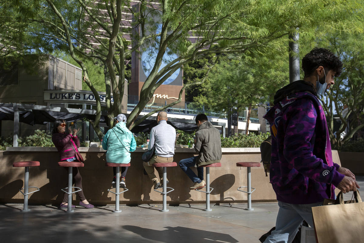Visitors to the Las Vegas Strip traded their summer attire for jackets on Monday, Oct. 26, 2020 ...