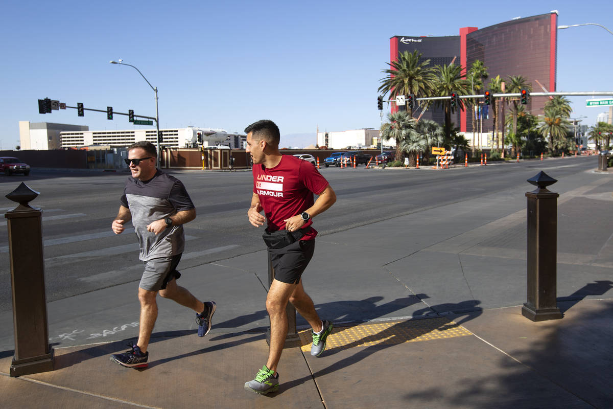 Runners take advantage of cooler weather on the Las Vegas Strip on Monday, Oct. 26, 2020. (Elle ...