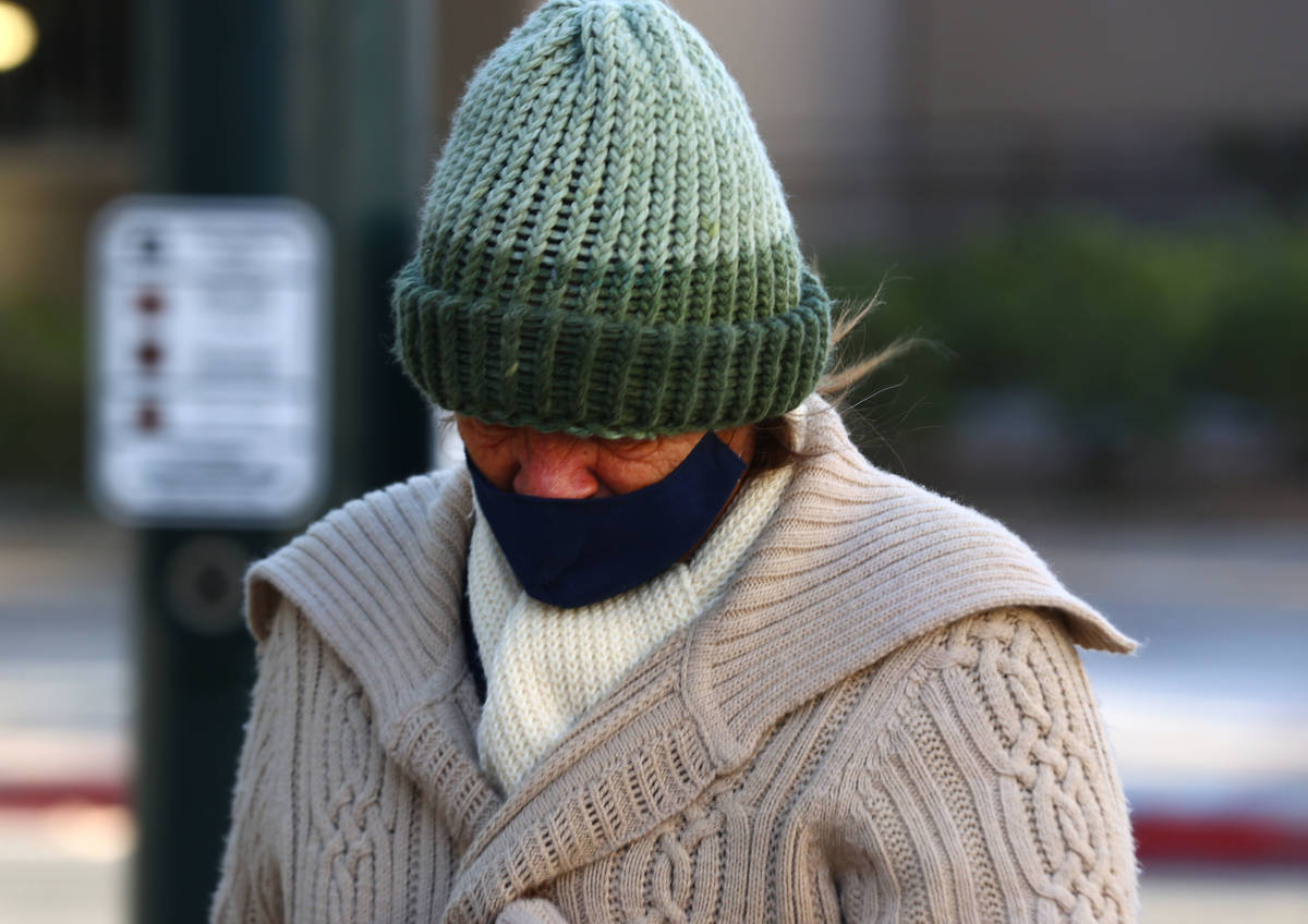 A pedestrian bundled up for cold weather as she walks along East Clark Avenue, on Monday Oct. 2 ...