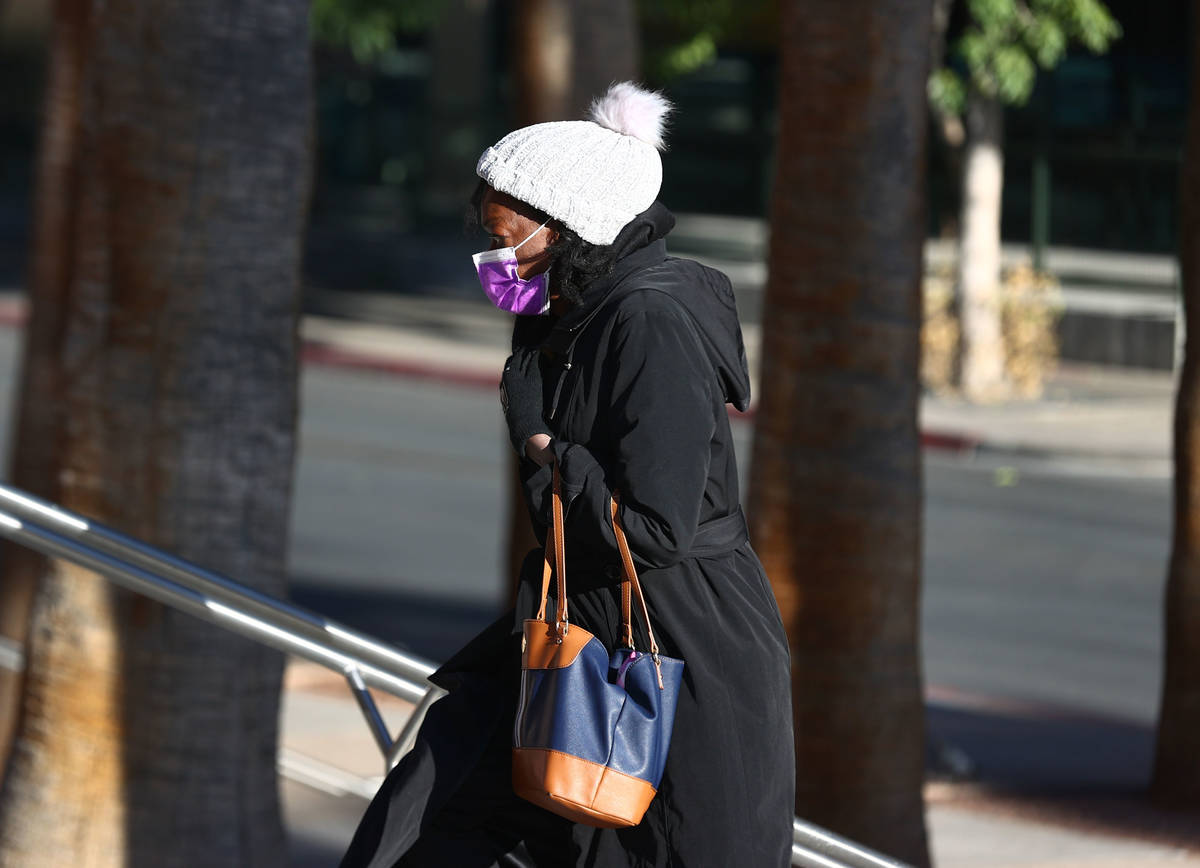 A woman bundled up for cold weather as she stands in line outside of the Regional Justice Cente ...