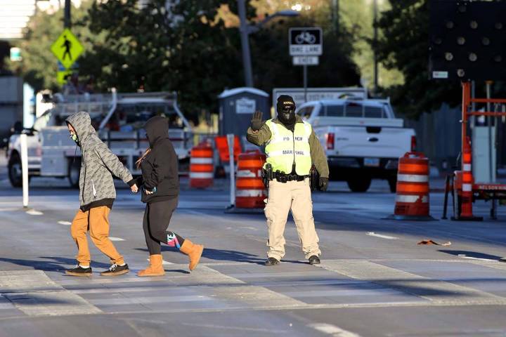 Deputy Marshal, David Muhr is bundled up for the chilly weather as he stops traffic for pedestr ...