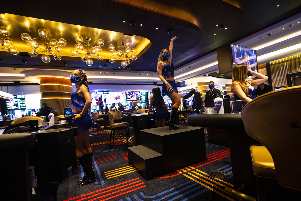 A dancer performs by table games at Circa during the VIP black-tie grand opening event in downt ...