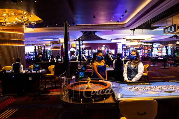 Table games dealers pose for photos during the VIP black-tie grand opening event at Circa in do ...