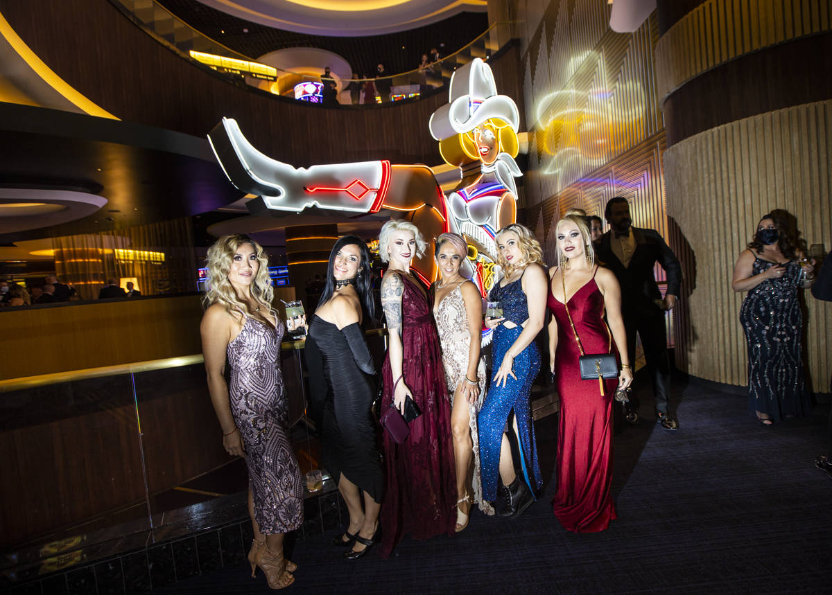 Invited guests pose for photos with Vegas Vickie at Circa during the VIP black-tie grand openin ...