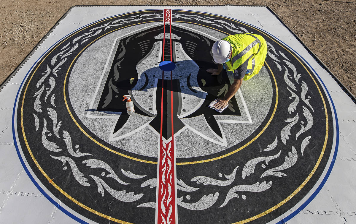Construction workers put the finishing touches on the Henderson Silver Knights logo during a co ...