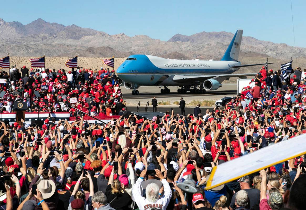Supporters cheer as Air Force One, carrying President Donald Trump, approaches the stage at Lau ...