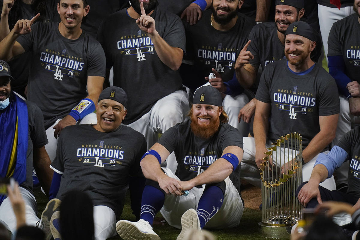 Los Angeles Dodgers manager Dave Roberts and third baseman Justin Turner pose for a group pictu ...