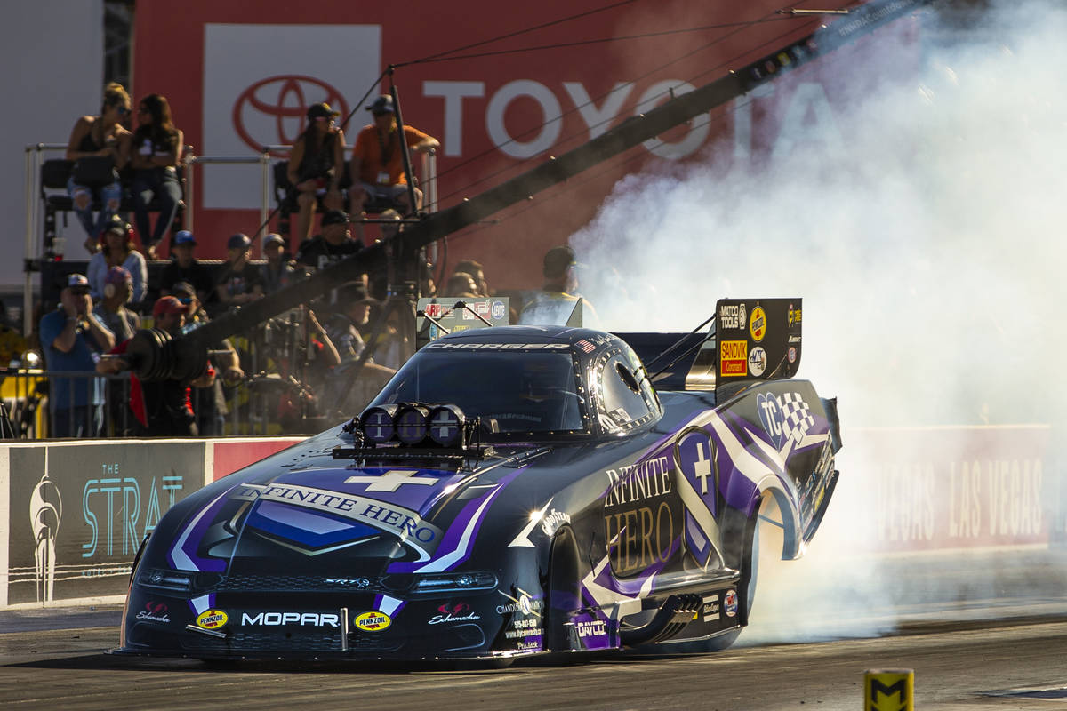 Funny Car racer Jack Beckman burns his tires during the second round of the Dodge NHRA National ...