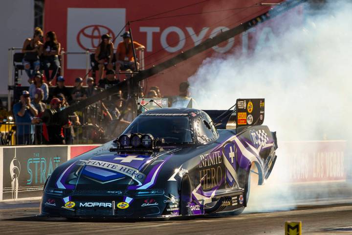 Funny Car racer Jack Beckman burns his tires during the second round of the Dodge NHRA National ...