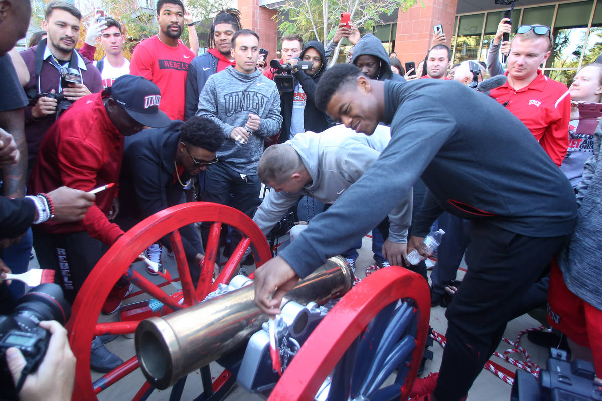 UNLV students and officials watch as UNLV's football players, including linebacker Javin White, ...