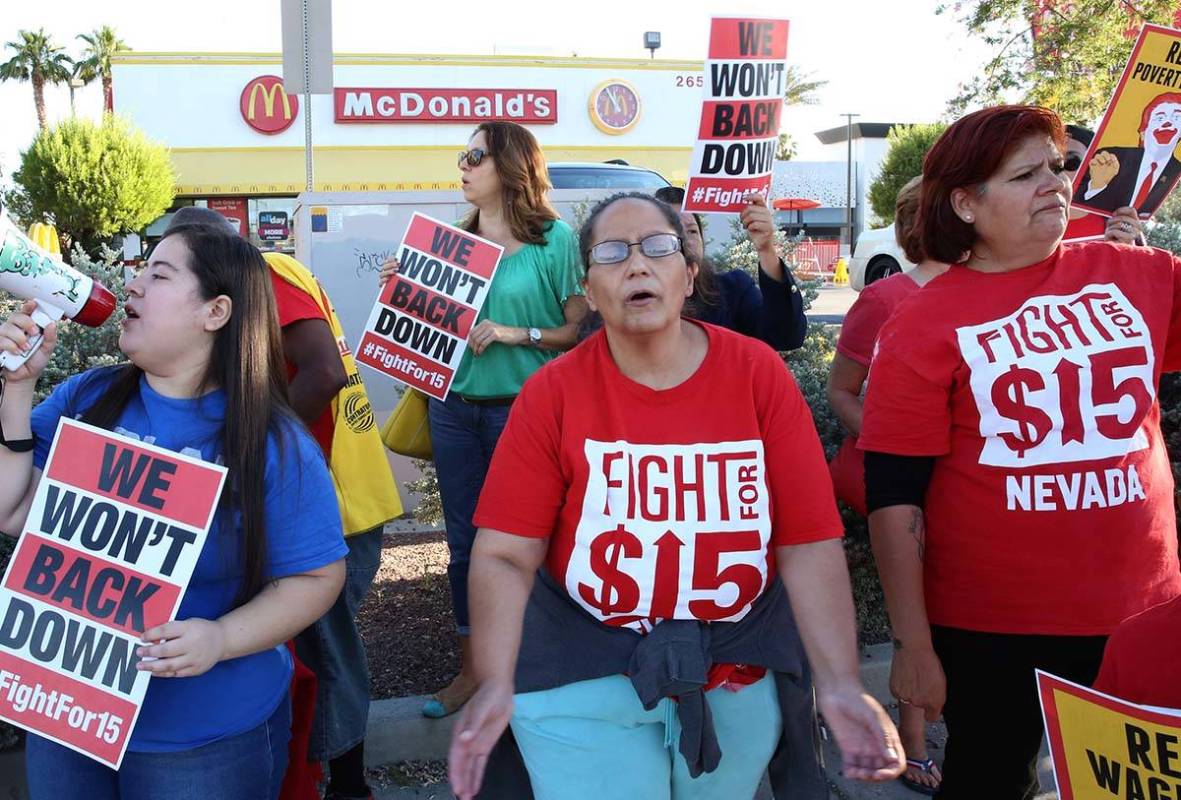 McDonald's franchise employees, including Diana Diaz, center, and Lupe Guzman, right, protest f ...