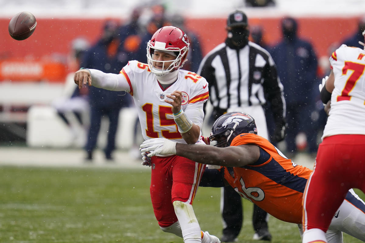 Kansas City Chiefs quarterback Patrick Mahomes throws a pass under pressure from Denver Broncos ...