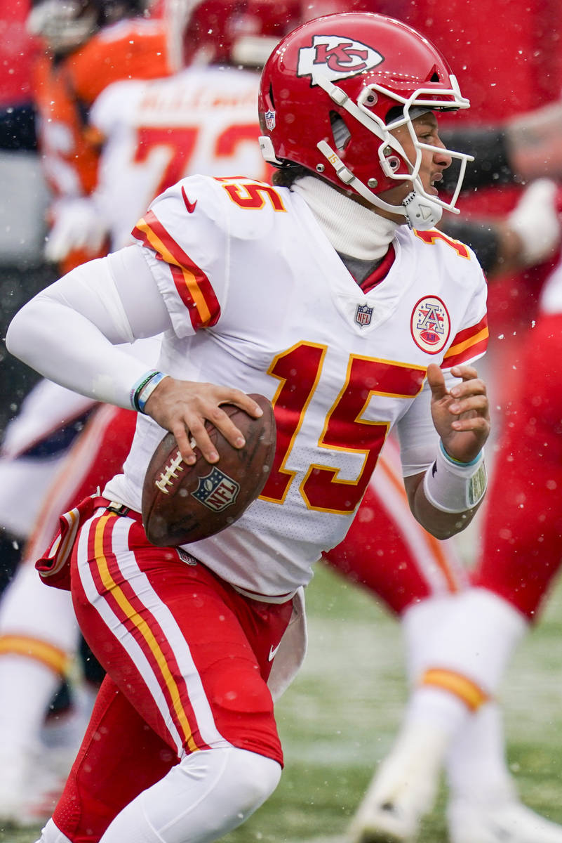 Kansas City Chiefs quarterback Patrick Mahomes (15) scrambles against the Denver Broncos during ...