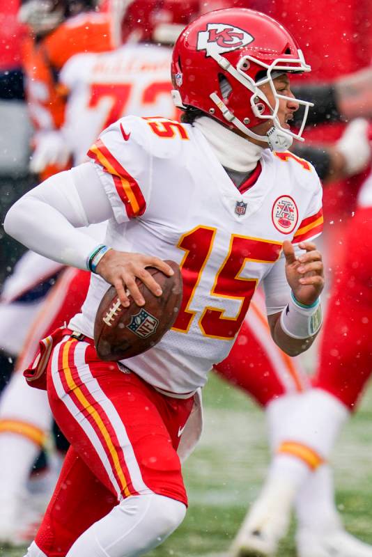 Kansas City Chiefs quarterback Patrick Mahomes (15) scrambles against the Denver Broncos during ...