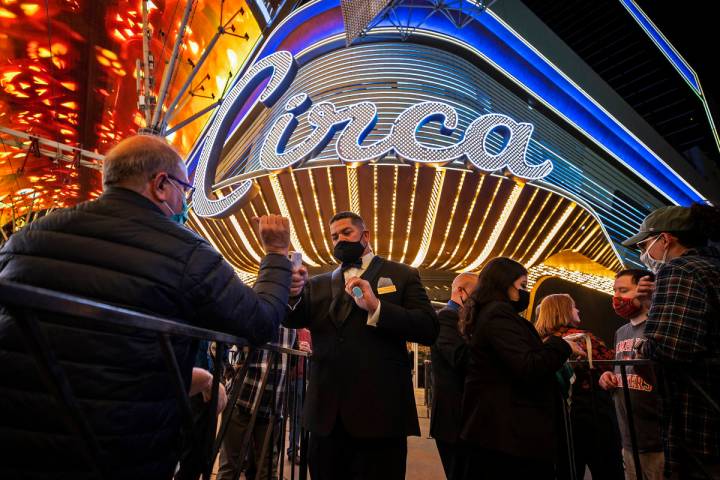 People get their temperature taken outside Circa while waiting to enter the resort for the fir ...