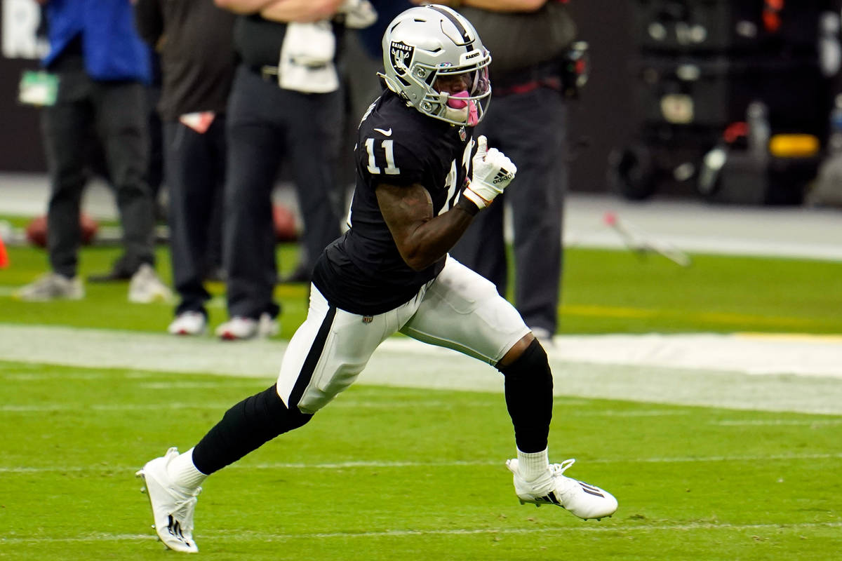 Las Vegas Raiders wide receiver Henry Ruggs III (11) runs the ball after a catch against the Ta ...