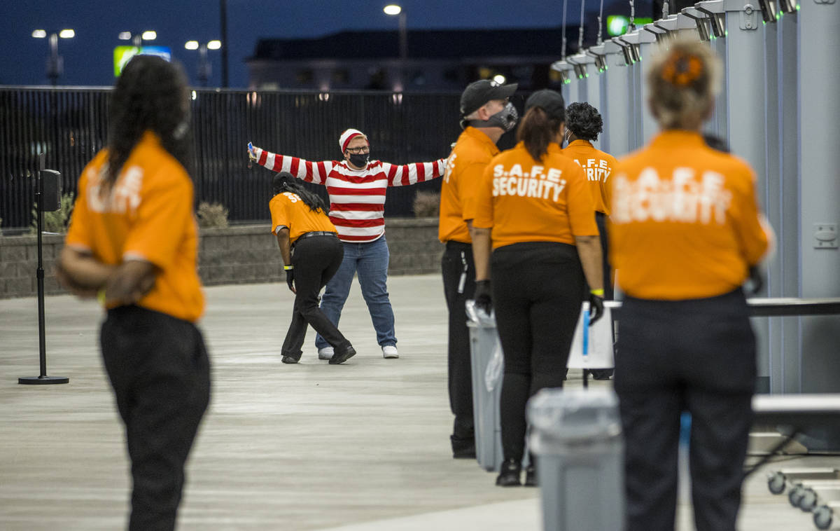 Fan Tia Cartwright is checked by security as she enters Allegiant Stadium for the UNLV versus ...