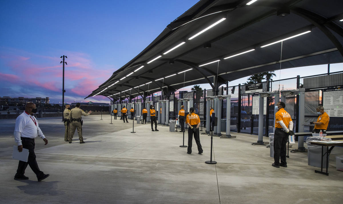 Security personnel are in place as fans enter Allegiant Stadium for the UNLV versus UNR footbal ...