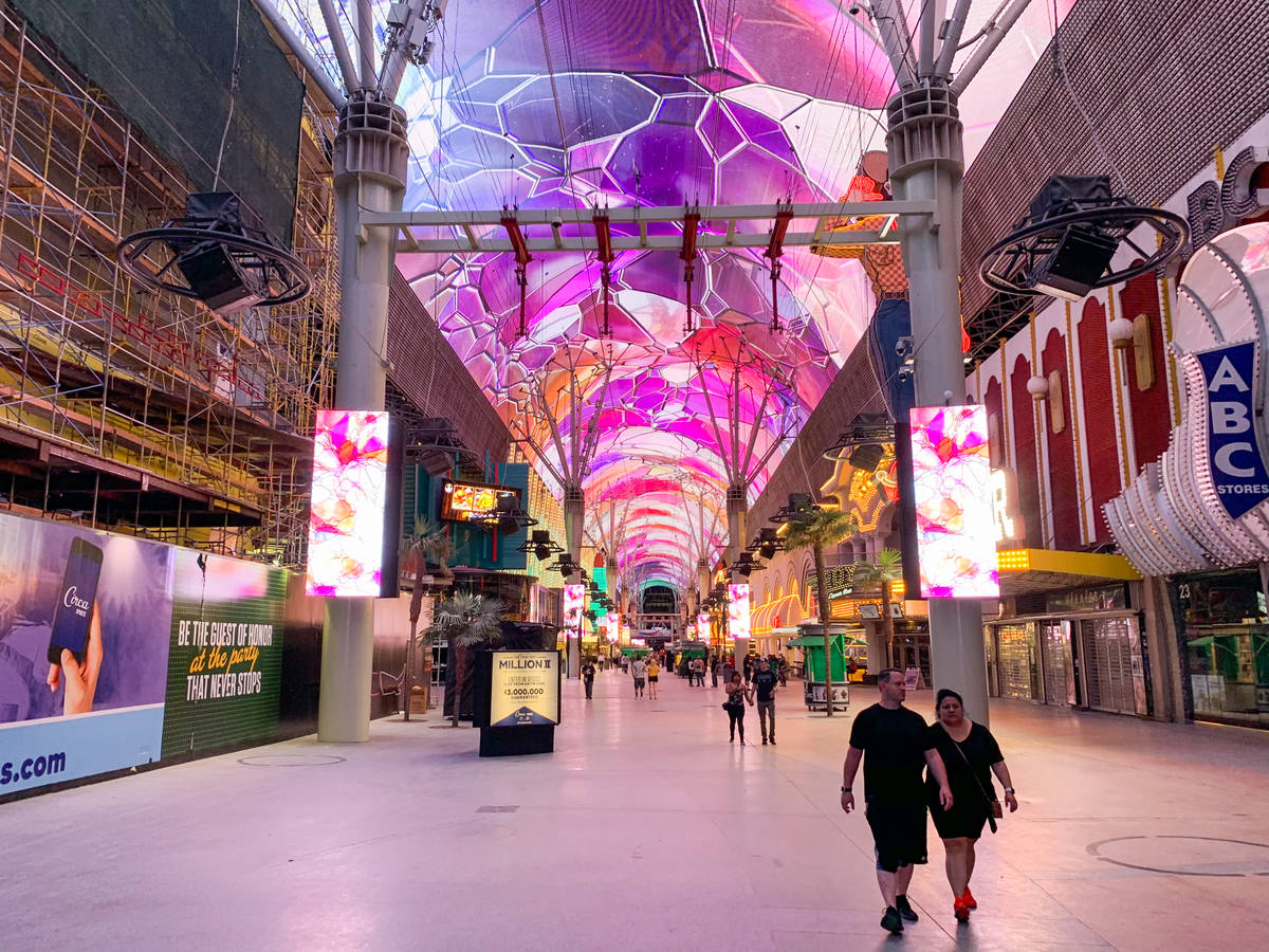 People walk along the Fremont Street Experience after casinos reopened in downtown Las Vegas on ...