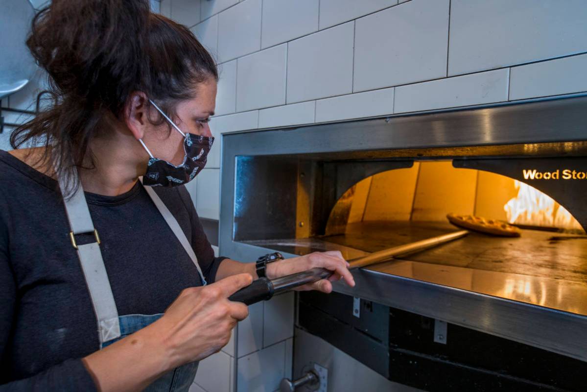 Executive Chef Gina Marinelli prepares a Pizza Margherita in her restaurant kitchen. (L.E. Baskow)