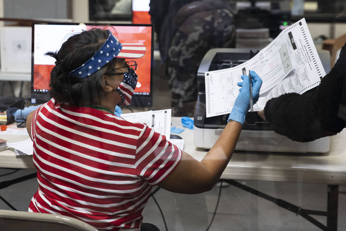 A Clark County election worker checks out ballots as workers prepare to count them at the Elect ...