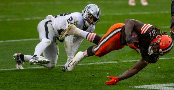 Las Vegas Raiders strong safety Johnathan Abram (24) tackles Cleveland Browns running back Kare ...