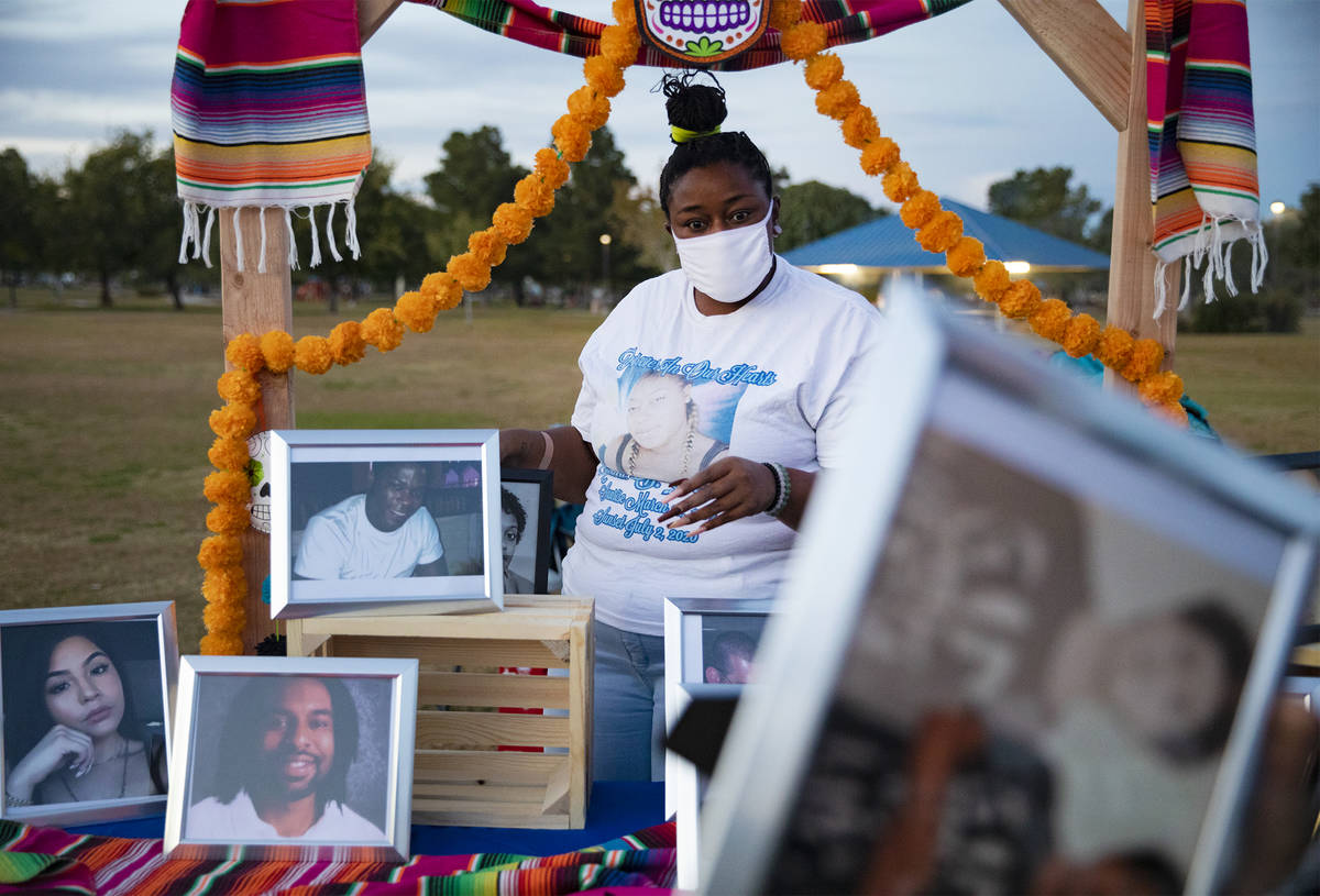 Kamwha Stevenson sets out photos of people killed by police violence at a Día de los Muert ...