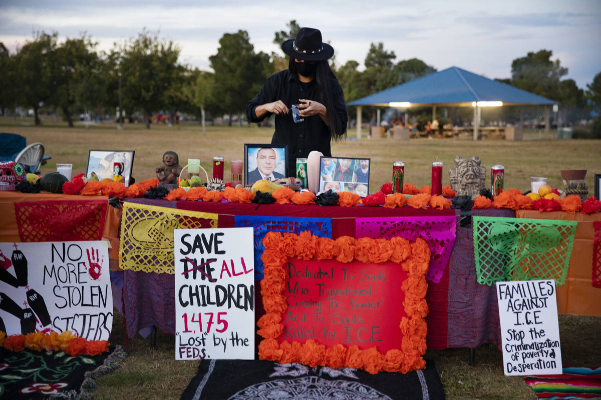 Davis Huskon sets up an ofrenda at a Día de los Muertos event to honor people killed by po ...