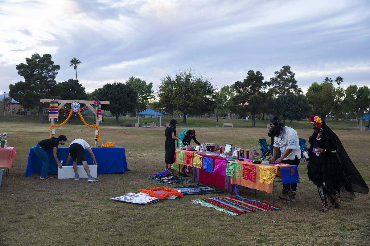 Volunteers set up an ofrenda at a Día de los Muertos event to honor people killed by polic ...