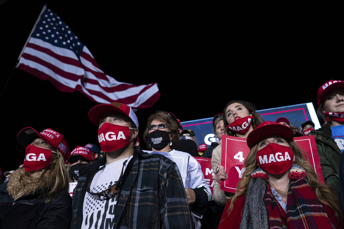 Supporters of President Donald Trump listen to him speak during a campaign rally at Richard B. ...