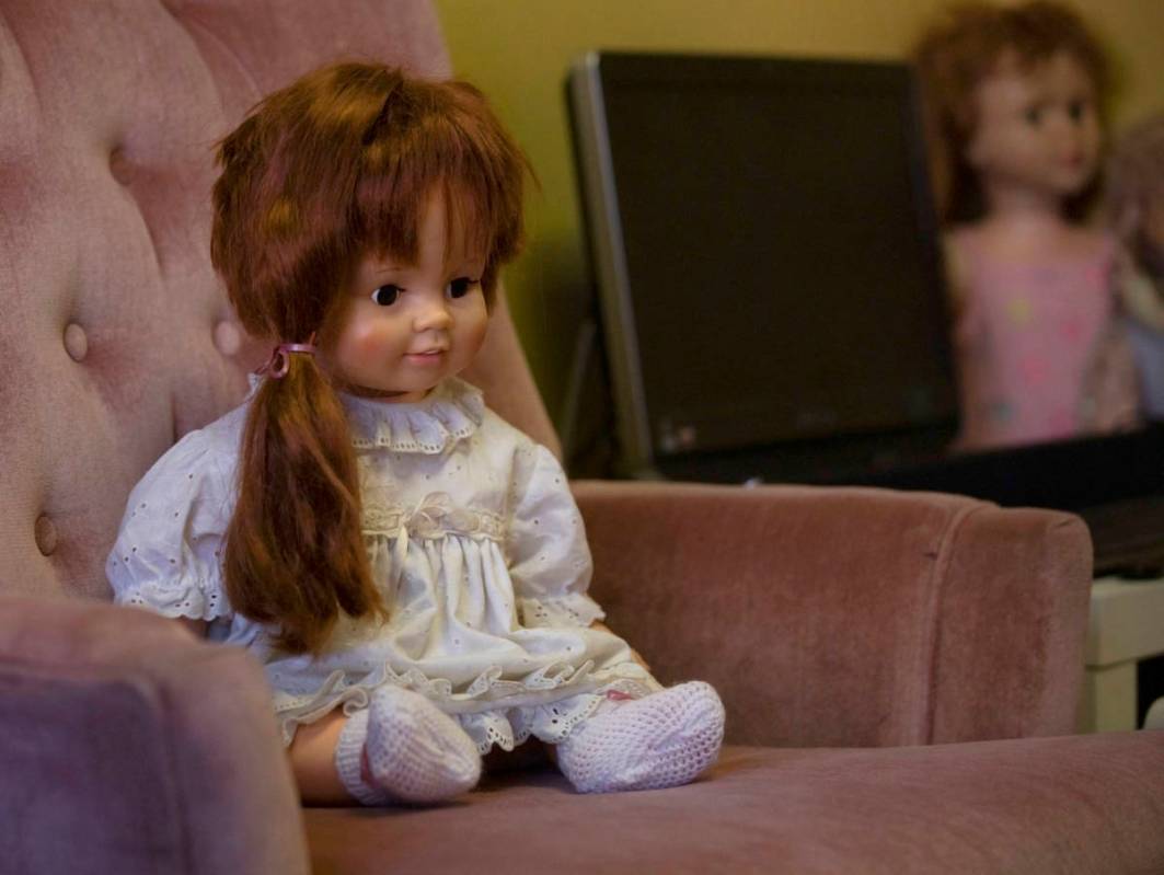 A doll that carries high activity, Katie, sits on a haunted chair in paranormal enthusiast Stay ...