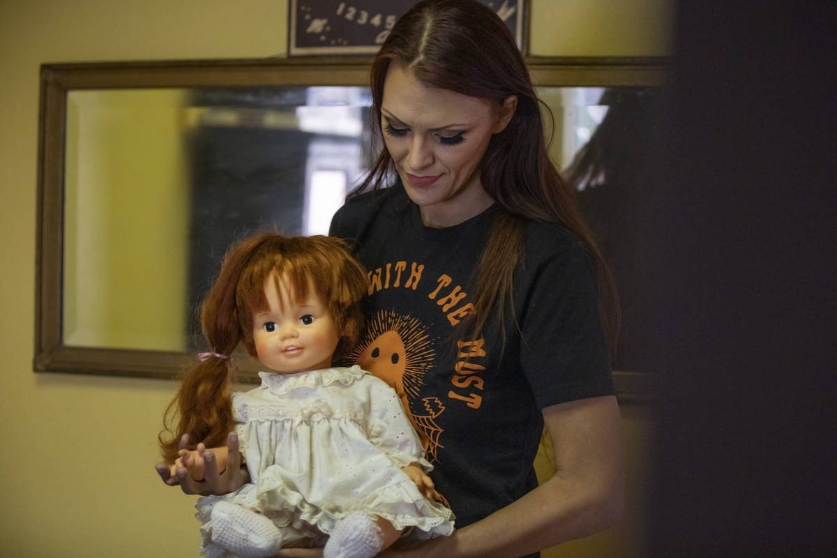 Paranormal enthusiast Staysha Randall is seen in front of a haunted mirror holding a doll named ...