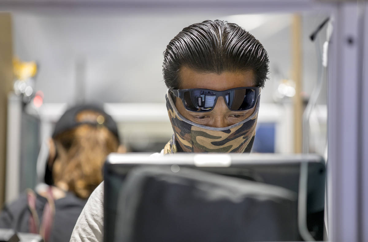 Voter Justin Nguyen casts his votes at the Meadows Mall vote center location during Election Da ...